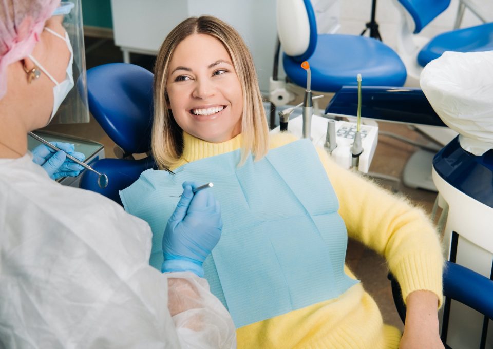 the-girl-smiles-at-the-dentist-and-looks-at-her.jpg